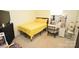 Cozy bedroom featuring carpet, a queen bed with yellow bedding, a desk area, and a closet at 12209 Riceland Way, Midland, NC 28107