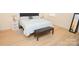 Bright bedroom features wood-look flooring, a padded headboard, and a modern bench at 12209 Riceland Way, Midland, NC 28107