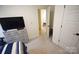 Bedroom showing carpet, an open door, a closet, a tv, and bed at 12209 Riceland Way, Midland, NC 28107