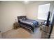 Bedroom with carpet, a bed with blue and white bedding, a desk area, and a window at 12209 Riceland Way, Midland, NC 28107