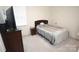 Bedroom with carpet, a queen bed with gray bedding, and a tv on a dresser at 12209 Riceland Way, Midland, NC 28107