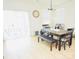 Bright dining room with hardwood floors, a dining table with chairs and bench, and a sliding glass door to the patio at 12209 Riceland Way, Midland, NC 28107