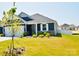 Charming home featuring a two-car garage, beautiful gray siding, and well-manicured lawn, creating great curb appeal at 12209 Riceland Way, Midland, NC 28107