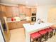 Bright kitchen features a center island, wooden cabinets, stainless steel appliances, and modern countertops at 12209 Riceland Way, Midland, NC 28107