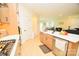 Modern kitchen features stainless steel appliances, a large island, and an open floor plan with hardwood flooring at 12209 Riceland Way, Midland, NC 28107