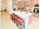 Modern kitchen with a large island, quartz countertops, stainless steel appliances, and stylish seating at 12209 Riceland Way, Midland, NC 28107