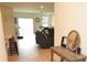 Open-concept living space featuring wood floors, modern decor, and a view into the dining area at 12209 Riceland Way, Midland, NC 28107