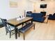 Inviting living area featuring hardwood floors, a wooden table with chairs and bench, with neutral paint colors at 12209 Riceland Way, Midland, NC 28107
