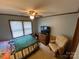 Comfortable bedroom with ceiling fan, natural light, and carpet flooring at 12623 Levins Hall Rd, Huntersville, NC 28078