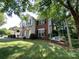 Charming two-story home with a front porch, swing and well-manicured landscaping at 12623 Levins Hall Rd, Huntersville, NC 28078