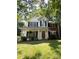 Inviting two-story home with a brick and siding exterior, American flag, and well-kept lawn at 12623 Levins Hall Rd, Huntersville, NC 28078