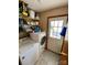 Functional laundry room with washer, dryer, shelving, and access door at 12623 Levins Hall Rd, Huntersville, NC 28078