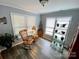 Cozy sitting room featuring hardwood floors, natural light, and a comfortable rocking chair at 12623 Levins Hall Rd, Huntersville, NC 28078