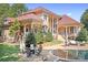 A lovely interlock patio, outdoor seating and a swimming pool at the back of the house at 149 Vista Bluff Ln, Mooresville, NC 28117