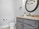 Cozy half bathroom features classic fixtures and elegant mirror at 149 Vista Bluff Ln, Mooresville, NC 28117