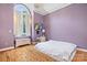 Bedroom with hardwood floors, large window, and white faux fur rug at 149 Vista Bluff Ln, Mooresville, NC 28117