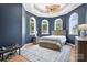 Comfortable bedroom boasts a tray ceiling, a ceiling fan and three large arched windows at 149 Vista Bluff Ln, Mooresville, NC 28117