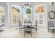 Cozy breakfast nook featuring a round table, comfortable chairs, and natural light through large windows with shutters at 149 Vista Bluff Ln, Mooresville, NC 28117