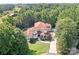 Stunning aerial view of a luxurious estate with a red tile roof, lush landscaping, and a sparkling pool at 149 Vista Bluff Ln, Mooresville, NC 28117