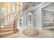 Elegant foyer with a curved staircase, mosaic floor design, and abundant natural light at 149 Vista Bluff Ln, Mooresville, NC 28117