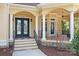 Elegant home featuring a grand entrance with a double door, columns, and manicured landscaping at 149 Vista Bluff Ln, Mooresville, NC 28117