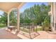 Covered patio overlooking the backyard, with a pool, manicured lawn, and mature trees for added privacy at 149 Vista Bluff Ln, Mooresville, NC 28117