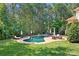 Relaxing backyard pool area with comfortable seating, surrounded by lush greenery and tall trees at 149 Vista Bluff Ln, Mooresville, NC 28117