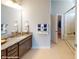 Double sinks and a glass enclosed shower are highlights of this bright primary bath at 152 Asmodean Ln, Troutman, NC 28166
