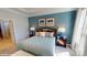Comfortable bedroom is painted light blue and includes coordinated furniture and linens at 152 Asmodean Ln, Troutman, NC 28166