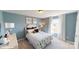 Cozy bedroom featuring a bed with floral bedding, side tables and bright windows at 152 Asmodean Ln, Troutman, NC 28166