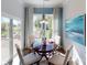 Cozy dining area features natural light, a round table, and seating for four near an outdoor patio at 152 Asmodean Ln, Troutman, NC 28166
