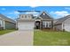 Charming single-Gathering home featuring stone accents and a well-manicured lawn at 152 Asmodean Ln, Troutman, NC 28166