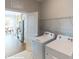 Functional laundry room with modern appliances, shelving for storage, and easy access to the kitchen at 152 Asmodean Ln, Troutman, NC 28166
