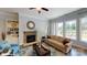 Inviting living room with a stone fireplace, modern furnishings, and natural light throughout at 152 Asmodean Ln, Troutman, NC 28166