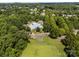 Wide aerial view of a community pool and clubhouse nestled among lush greenery, offering a resort-like atmosphere at 15211 Colonial Park Dr, Huntersville, NC 28078