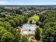 Overhead view of a community pool surrounded by mature trees and neighborhood homes, creating a private oasis at 15211 Colonial Park Dr, Huntersville, NC 28078