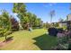 Expansive backyard showcasing the patio, outdoor grill, lush lawn, and playset, perfect for Gathering time at 15211 Colonial Park Dr, Huntersville, NC 28078