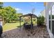 Beautiful backyard patio with a shaded pergola and outdoor dining set, ideal for entertaining guests at 15211 Colonial Park Dr, Huntersville, NC 28078