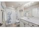 Bright bathroom featuring a shower-tub combo and large vanity with storage at 15211 Colonial Park Dr, Huntersville, NC 28078