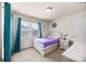 Comfortable bedroom with a white bed frame, purple comforter, and ample natural light at 15211 Colonial Park Dr, Huntersville, NC 28078