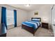 Comfortable bedroom with neutral carpet, blue comforter, and ample natural light at 15211 Colonial Park Dr, Huntersville, NC 28078