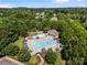 Stunning aerial view of the community pool with ample seating and lush landscaping, perfect for summer relaxation at 15211 Colonial Park Dr, Huntersville, NC 28078