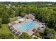 Gorgeous aerial view of a community pool with a lounge area, and mature trees, offering a serene retreat at 15211 Colonial Park Dr, Huntersville, NC 28078