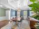 Elegant dining room with coffered ceiling, stylish lighting, and ample natural light at 15211 Colonial Park Dr, Huntersville, NC 28078