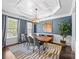 Sophisticated dining room with a coffered ceiling, designer light fixture, and an inviting atmosphere at 15211 Colonial Park Dr, Huntersville, NC 28078