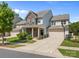 Charming two-story home with stone accents, manicured lawn, and a welcoming front porch at 15211 Colonial Park Dr, Huntersville, NC 28078
