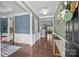 Bright and airy foyer with hardwood flooring, elegant wainscoting, and a seamless flow to the living spaces at 15211 Colonial Park Dr, Huntersville, NC 28078