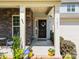 Inviting front porch features stone accents, elegant columns, and a decorative wreath on the front door at 15211 Colonial Park Dr, Huntersville, NC 28078