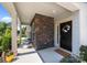 Charming front porch adorned with a seasonal wreath, stone accents, and ample space for seating at 15211 Colonial Park Dr, Huntersville, NC 28078