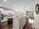 Spacious open-concept kitchen with modern appliances, granite countertops, and seamless flow to the living area at 15211 Colonial Park Dr, Huntersville, NC 28078